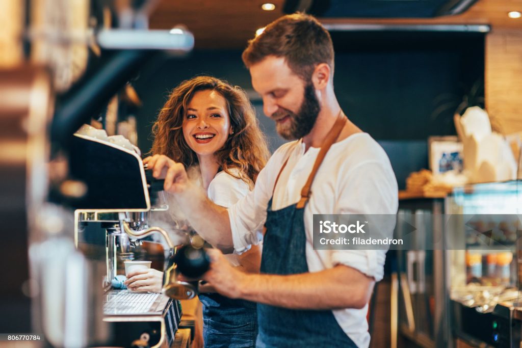 Baristas making coffee at a coffee shop.